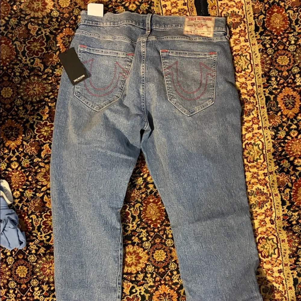 True Religion Men’s Ricky Relaxed Jeans in Light Blue with Red Stitching